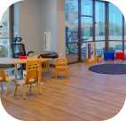 an icon of the play room in the Scottsdale Children's Institute with tables, chairs, and toys