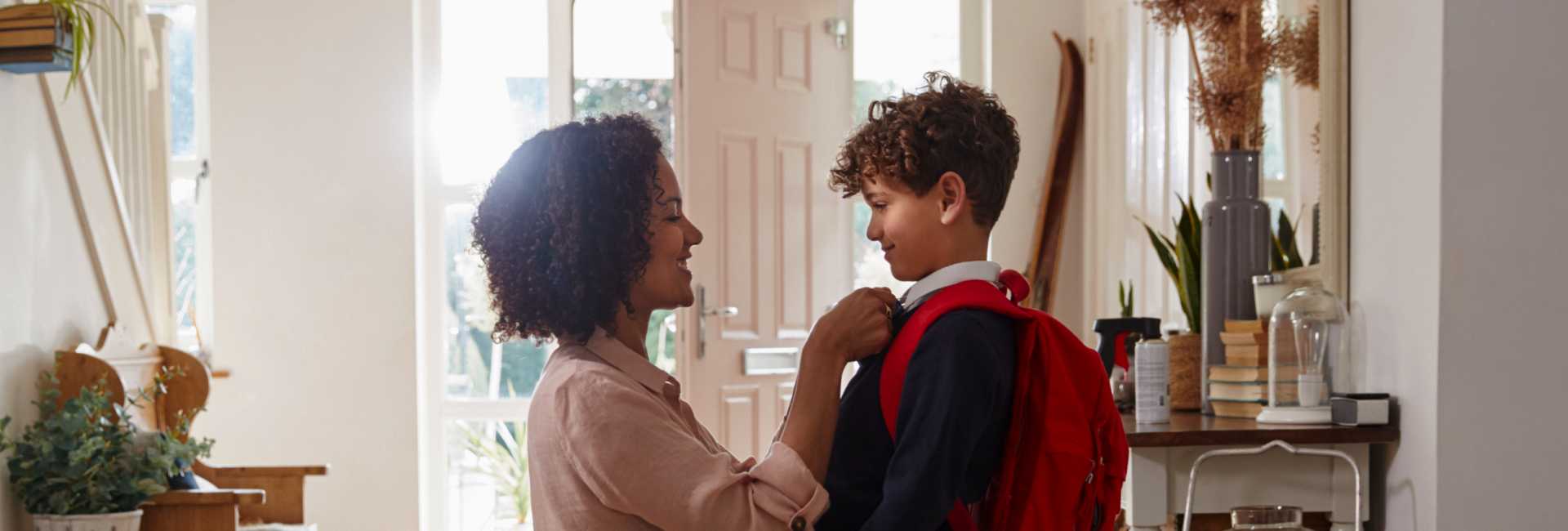 a woman sends her young son off to school