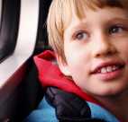 a young boy looks out the window