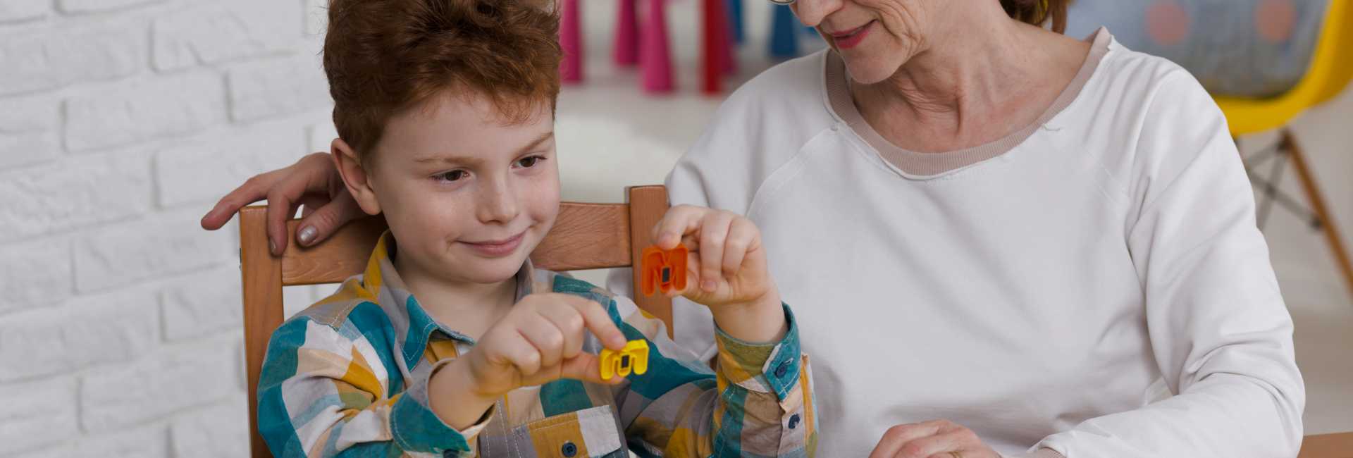 an older woman and a child play with toys