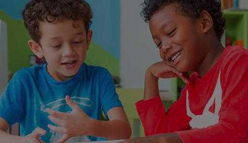 two children talking and smiling together