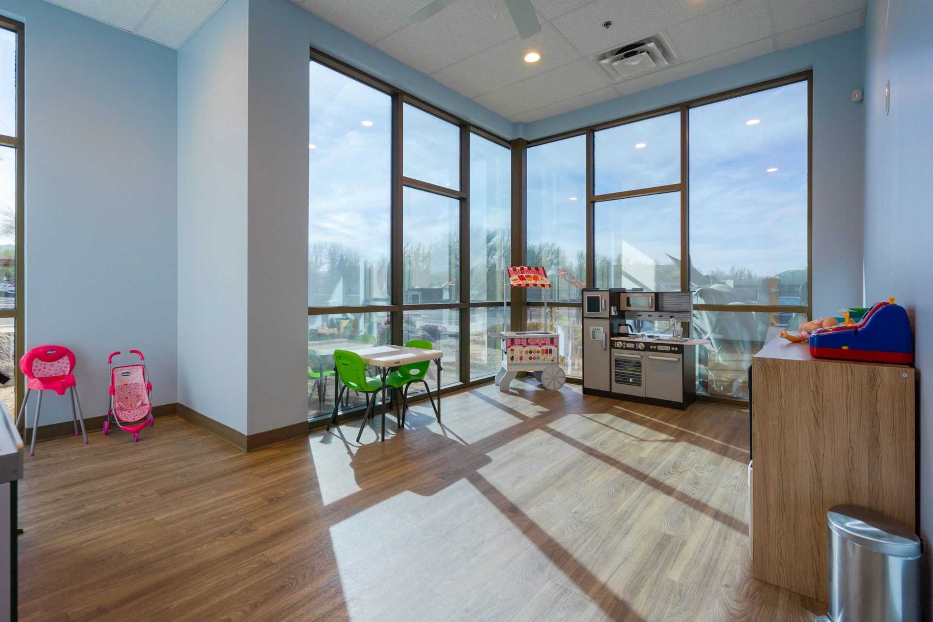 a playroom of the Scottsdale Children's Institute featuring tables and chairs