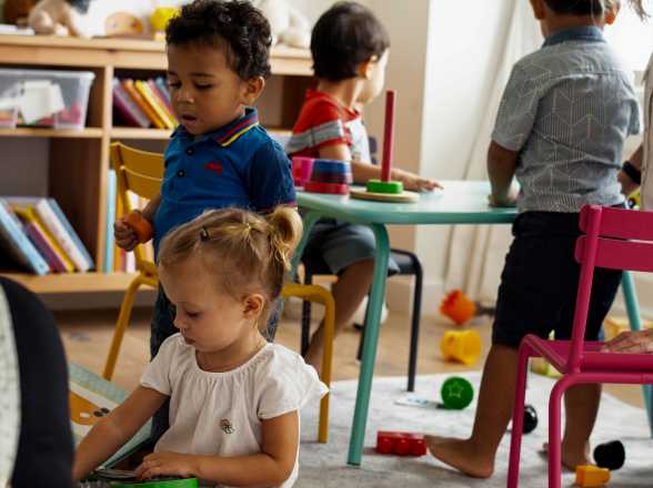 children play with toys at tables